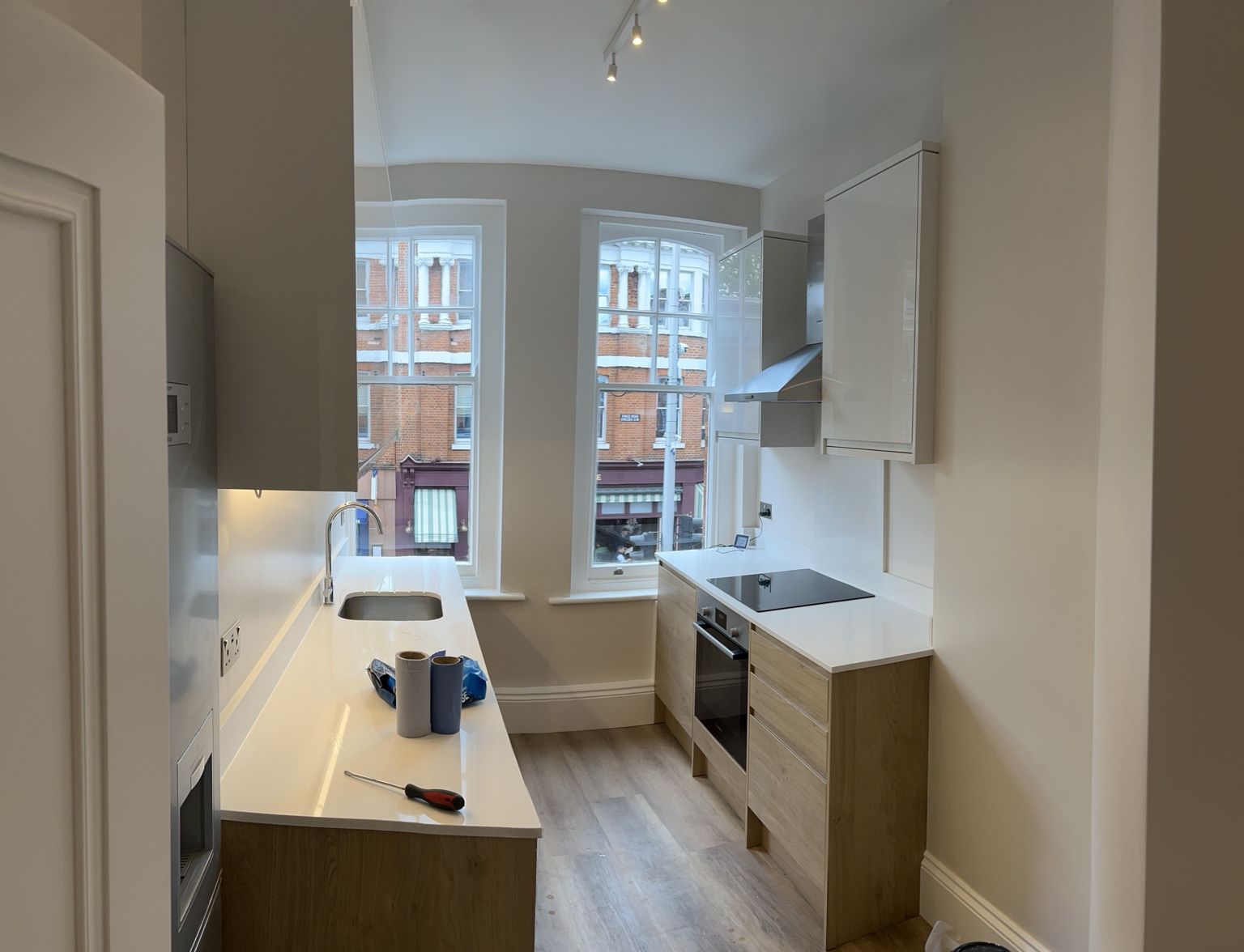 Kitchen installation with oak units and white worktops