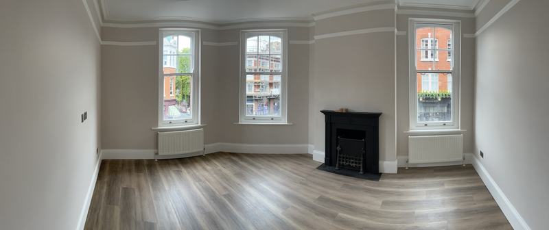 Refurbished living room with fireplace and new flooring