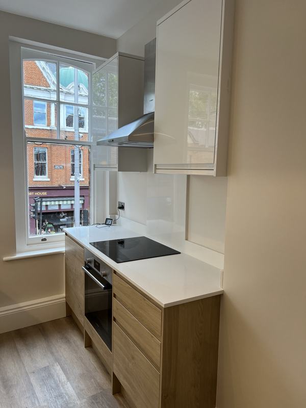 Galley kitchen with oak drawers and induction hob